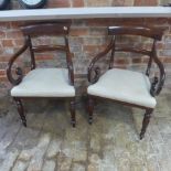 A NEAR pair of 19th century mahogany scroll carver armchairs