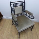 A Victorian ebonised William Morris / Sussex style open armchair with padded back arms and seat, one