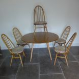 An Ercol Golden Dawn elm drop leaf dining table with 5 stick back chairs - table height 73cm x