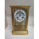 A gilt brass 4 glass mantle clock with exposed escapement, 25cm tall x 15cm wide, in running