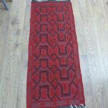 A small rug with a red field, 155cm x 50cm