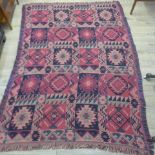 A Kilim rug with a red field, 175cm x 127cm