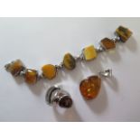 A silver amber ring, pendant and bracelet