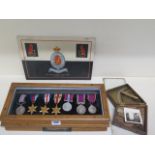 A cased set of 6 WWII medals in an oak case, a plaque reading 'These medals were awarded to B.S.M