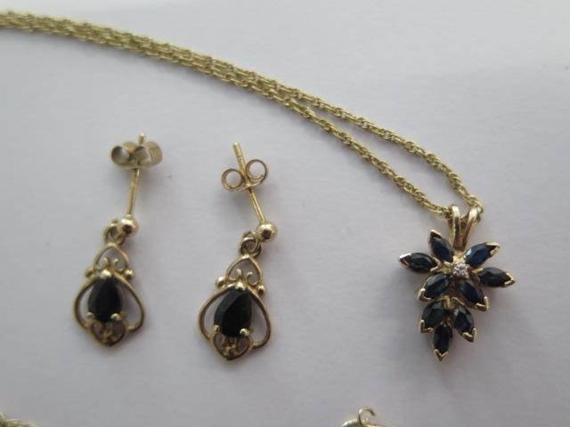 A 9ct yellow gold sapphire pendant on a chain and a pair of sapphire earrings - total approx - Image 2 of 2