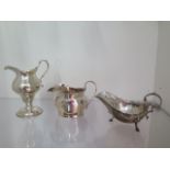 An engraved silver cream jug, a silver sauce boat and a silver milk jug - total weight approx 8.8