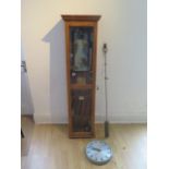 An oak cased Gent master clock with a magenta wall clock