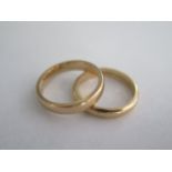 A 9ct yellow gold band ring, size L/M, approx 4 grams, and a 14ct band ring, size M/N, approx 3.3
