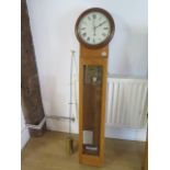 An oak cased electric master clock with 10" dial - Height 145cm