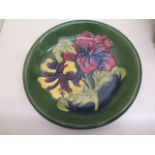 A Moorcroft green ground plate - Diameter 22cm - some crazing but generally good