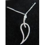 A contemporary 18ct white gold chain and pendant designed as an open leaf, chain length approx