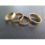Four 9ct yellow gold band rings, sizes O, R and U, total approx 16.8 grams