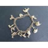 A 9ct yellow gold charm bracelet with 11 charms, total approx 25.7 grams