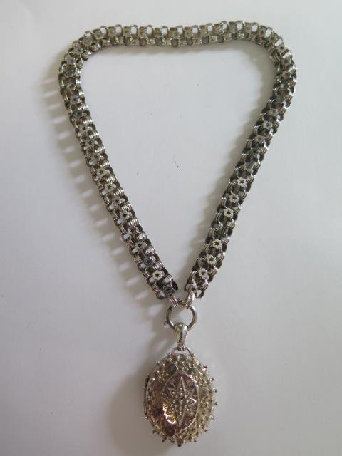 A silver locket, Birmingham 1892, 4cm tall, on a white metal chain in good condition, approx 26