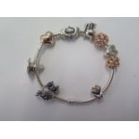 A Pandora charm bracelet with 8 charms, in good condition