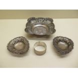A pair of silver sweetmeat dishes, a silver centre dish and a silver napkin ring, approx 7 troy oz