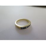 A gilt metal ring, size O, approx 4 grams, surface tests to approx 18ct, some small usage marks,