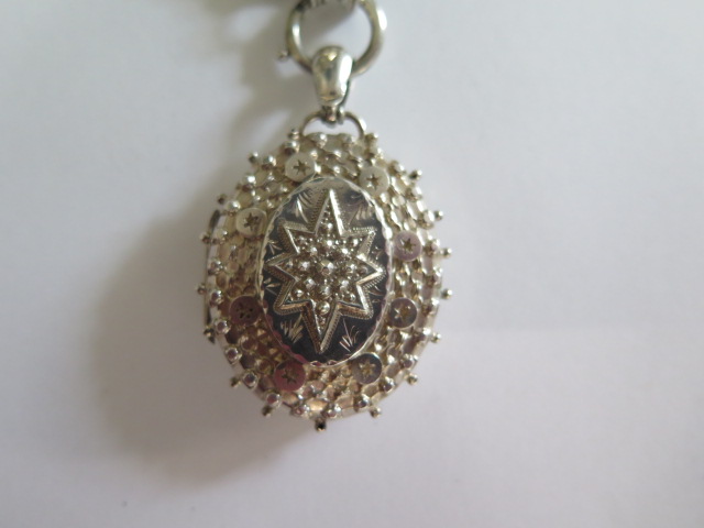 A silver locket, Birmingham 1892, 4cm tall, on a white metal chain in good condition, approx 26 - Image 3 of 8