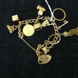 A 9ct yellow gold charm bracelet with 9 charms / fobs and 2 coin mounts, total approx 49.6 grams