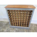 A shabby chic 64 bottle painted wine rack with a polished top made by a local craftsman to a high
