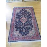 A Persian rug with a blue field - 210cm x 130cm - in good condition