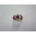 A yellow gold diamond and ruby type cluster ring - surface tests to approx 18ct - with a central