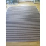 A Lloyd Loom fibre rug - 3m x 2.40m - in good condition