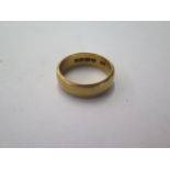 An 18ct yellow gold band ring size S - approx weight 9 grams - 6.9mm band - some usage marks but