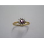 An 18ct yellow gold diamond and ruby type cluster ring size V - approx weight 3.5 grams - in good