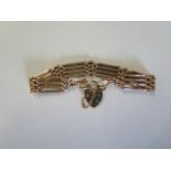 An Edwardian 15ct Rose Gold (marked to the large link) 4 Bar Gate Bracelet with a 9ct Padlock, Total