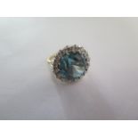 A 9ct yellow gold diamond and blue stone ring (possibly Zircon or Topaz) the centre stone approx