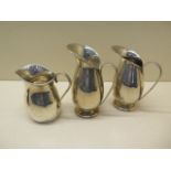 A pair of silver jugs - Height 11cm and a silver cream jug - total weight approx 10.6 troy oz - some