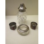 Two silver napkin rings, a silver rimmed dish and a silver top sifter - weighable silver approx 3