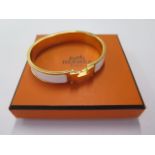 A Hermes Clic H bracelet with box, bag, ribbon - overall external 65mm x 57mm - in good condition,