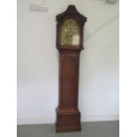An oak 8 day striking longcase clock with a brass arched 12" dial signed Peter Boyce Beccles with