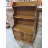 An Ercol waterfall bookcase with two base drawers - Height 102cm x Width 61cm