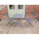 A grey metal folding patio table and chairs