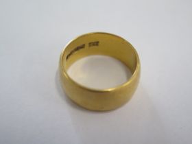 A hallmarked 22ct yellow gold band ring size N - 8mm band - approx weight 9.4 grams - some usage