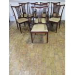 A set of eight early 1900's mahogany dining chairs with upholstered drop in seats including two