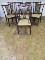 A set of eight early 1900's mahogany dining chairs with upholstered drop in seats including two