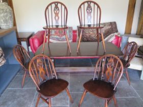 A vintage Ercol dining table and six matching chairs - 150cm x 75cm