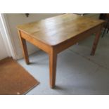 A 19th century stripped pine kitchen table with a drawer on square tapering legs - Height 77cm x
