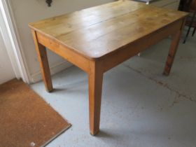 A 19th century stripped pine kitchen table with a drawer on square tapering legs - Height 77cm x