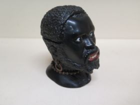 A carved wooden Blackamoor head desk inkwell with a hinged section revealing a metal inkwell -