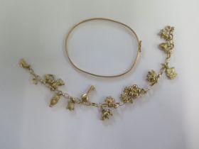 A 9ct yellow gold charm bracelet - Length 19cm - and a thin 9ct yellow gold bangle - total weight