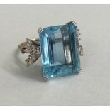 A good aquamarine and diamond white metal ring (possibly platinum) the large emerald cut