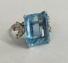 A good aquamarine and diamond white metal ring (possibly platinum) the large emerald cut