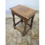 An oak stool with a carved frieze - Height 56cm x 43cm x 28cm