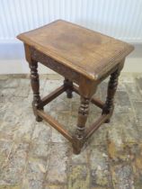 An oak stool with a carved frieze - Height 56cm x 43cm x 28cm