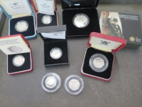 Eight silver proof coins - 3 x 50p, 3 x £1, 1 x £2 and a Churchill £5 - approx total weight 100